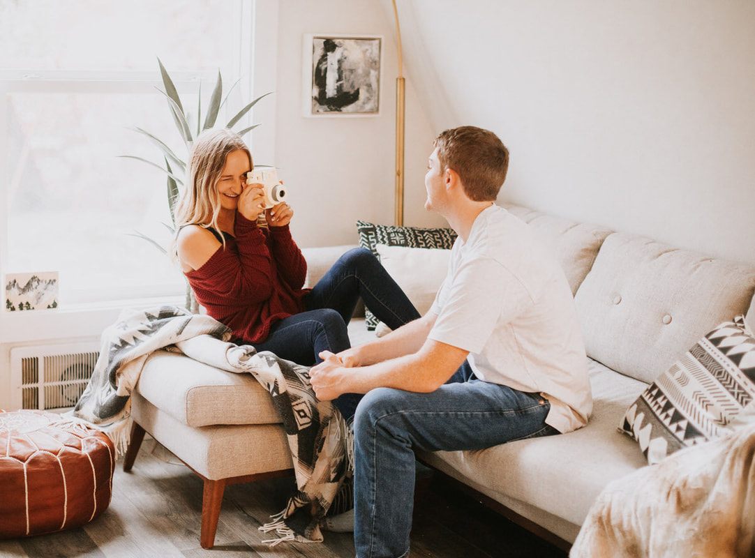 Couple laughing together inside the vintage-decorated cabin
