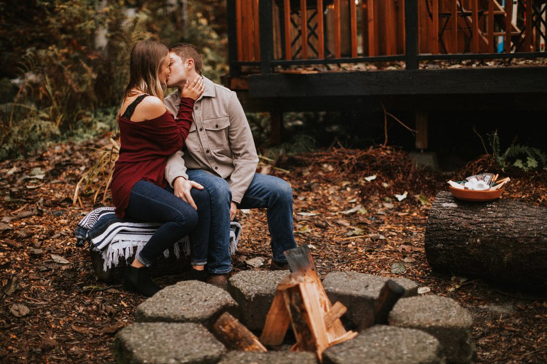 Couple gathered around the fire pit outside That PNW Cabin