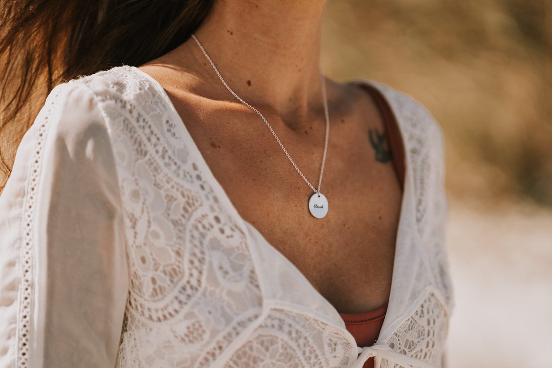 Hand stamped necklace from Maple Lane Jewelry photographed against a clean background