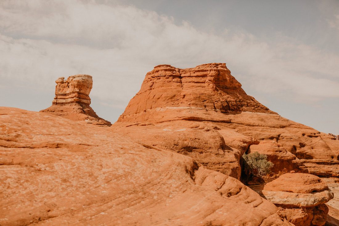 Photo of a wide open desert road cutting through canyon country in Colorado & Utah