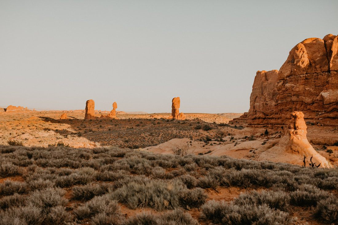 Photo of golden hour light on red rock formations in Colorado & Utah