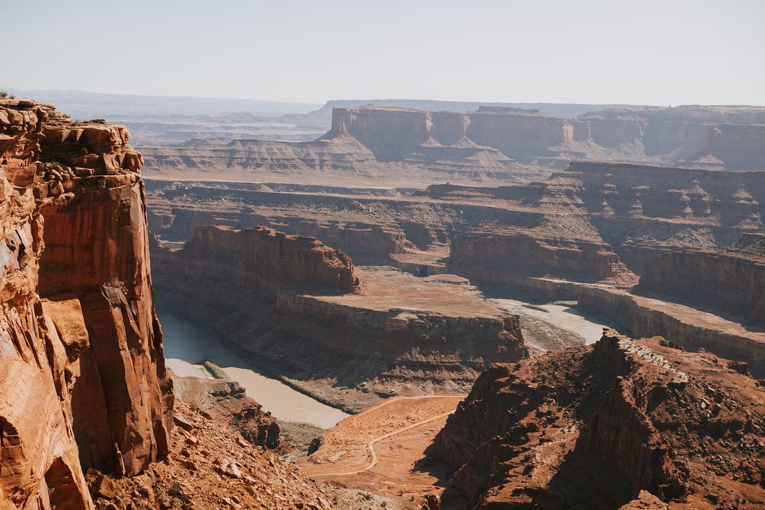 Photo of layered mountain ridgelines seen from a scenic overlook in Colorado & Utah