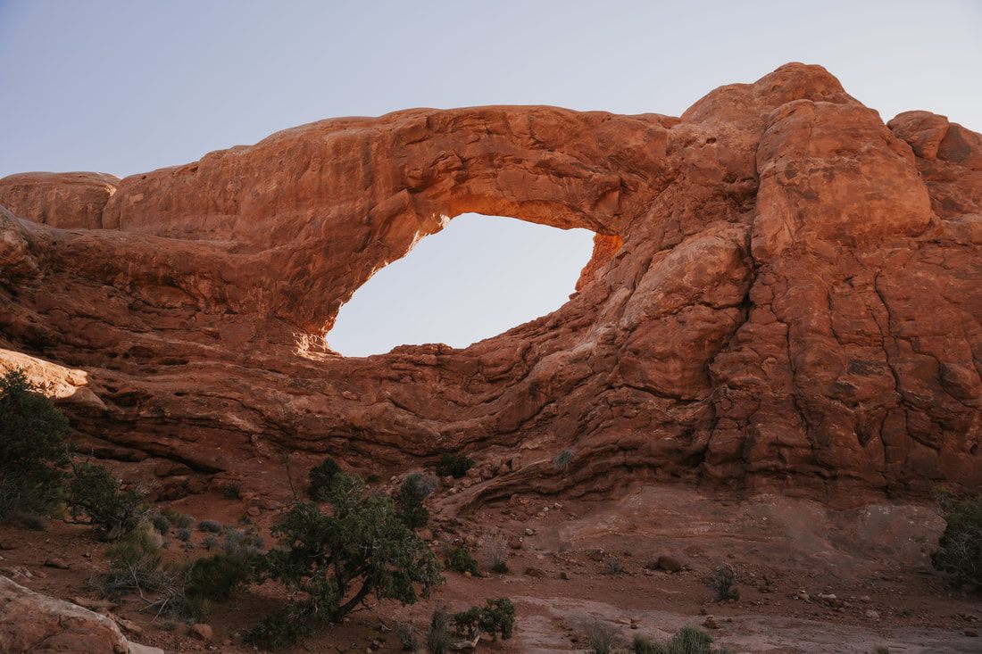 Photo of golden hour light over a van life campsite in Colorado & Utah