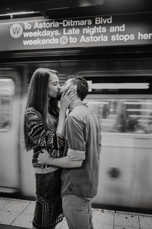 Engaged couple laughing together on a New York City sidewalk