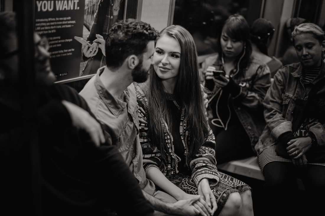 Couple laughing together against a backdrop of New York City lights