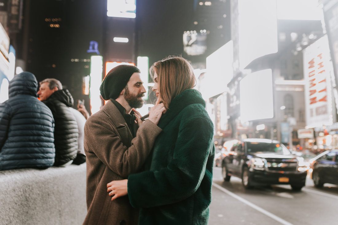 Engaged couple sharing a laugh on a New York City corner