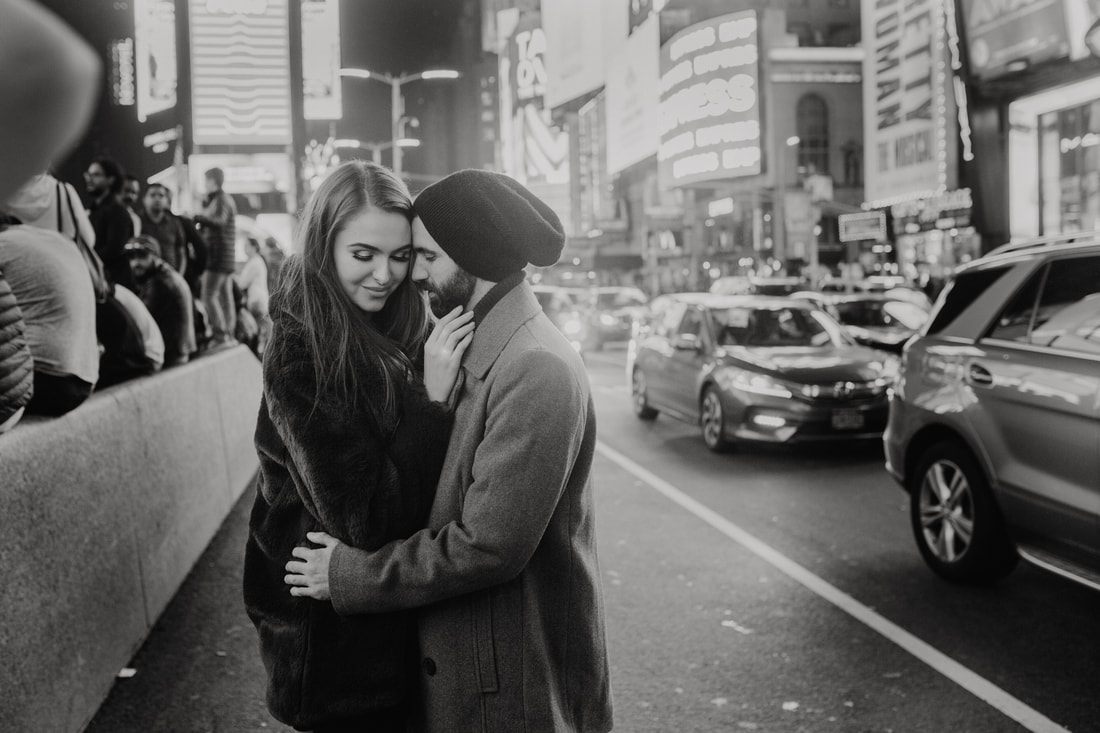 Couple embracing on a busy New York City sidewalk