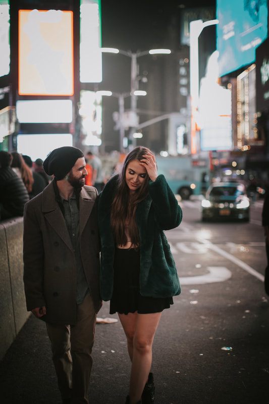 Engaged couple walking arm in arm through New York City