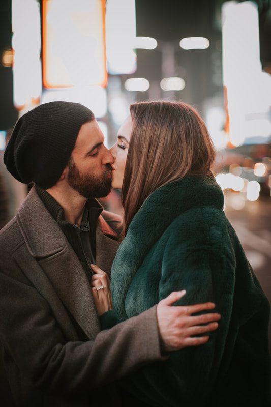 Couple laughing together near a New York City storefront
