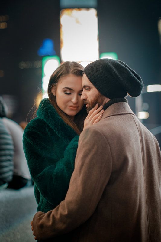 Couple walking together down a New York City street at night