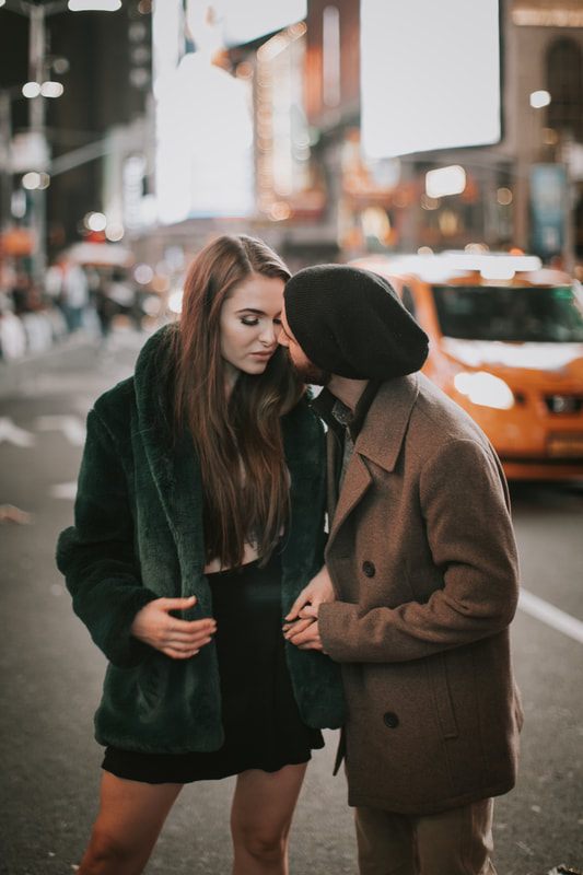 Engaged couple portrait lit by New York City street lights