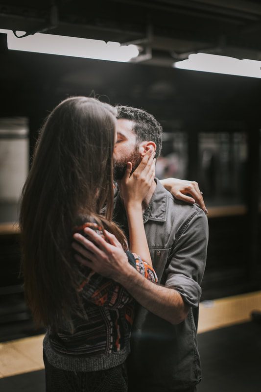 Couple standing together under the bright lights of Times Square