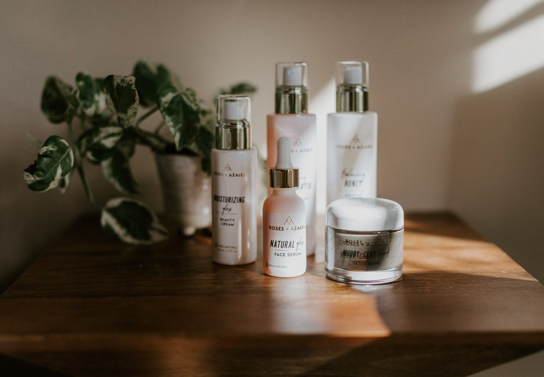 Organic skincare products from Roses and Azalea arranged in soft natural light.