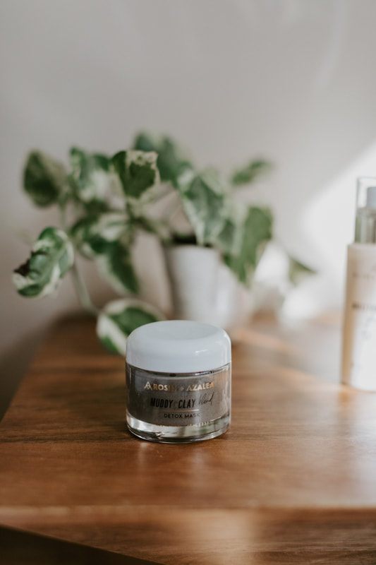 Skincare product photo featuring an all-natural formula bottle with fresh florals.
