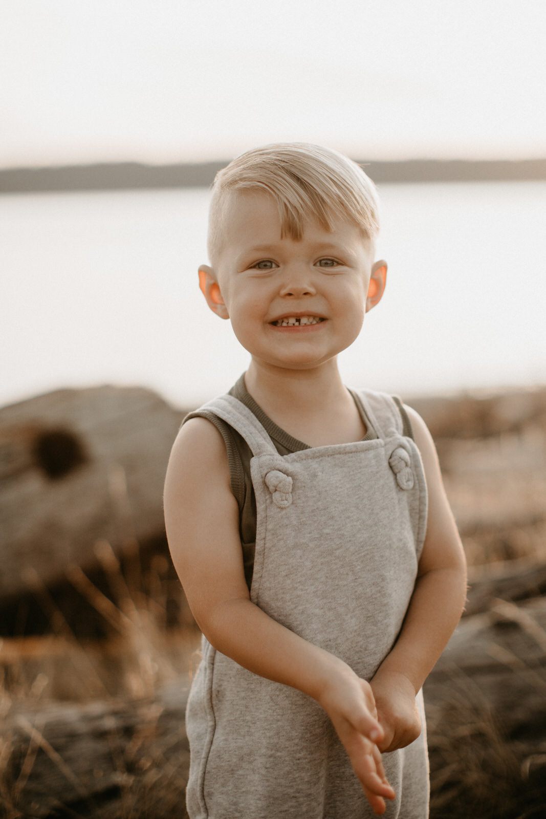 Two young brothers laughing together during a Seattle beach family session