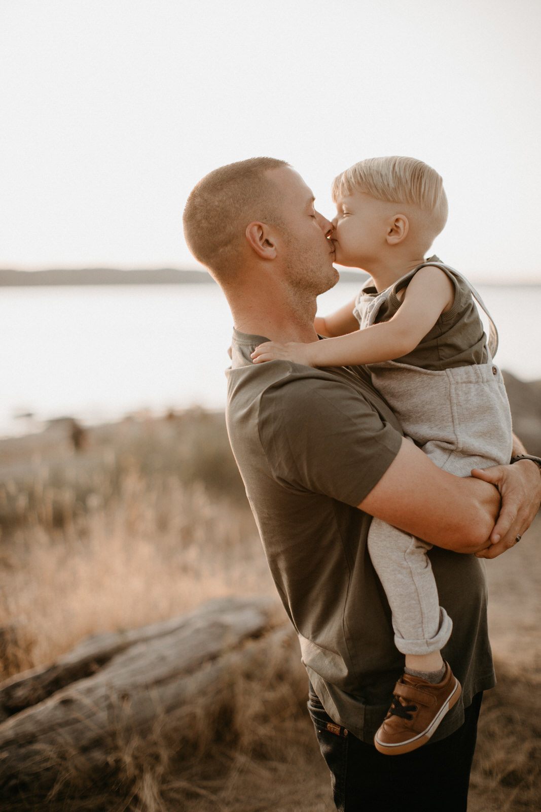 Brothers in overalls playing near the water during a PNW family photo session