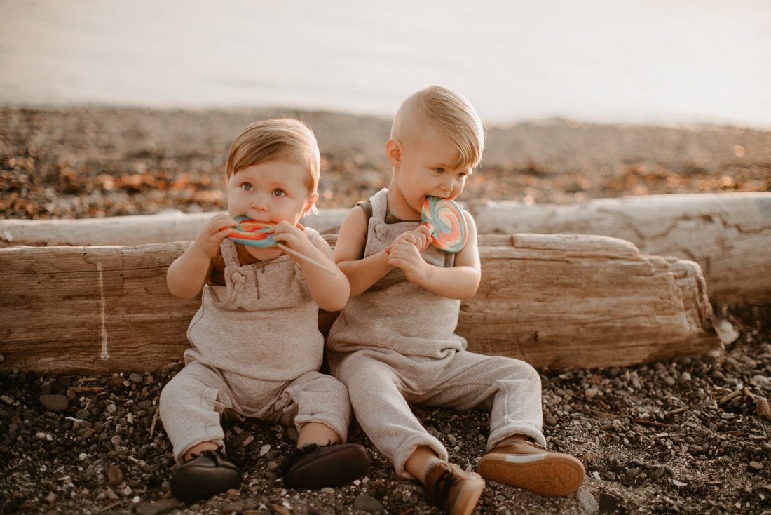 Brothers running along the shoreline during a family photography session