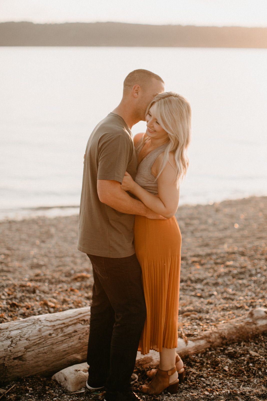 Siblings sitting together in the sand during a Seattle family session