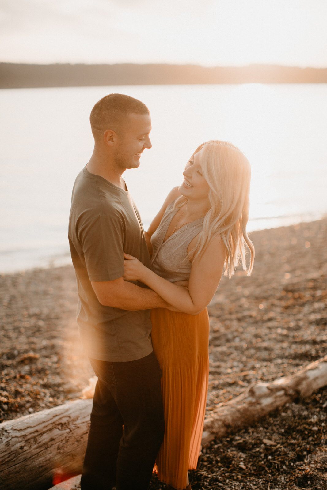 Family laughing together during a relaxed beach photo session in Washington