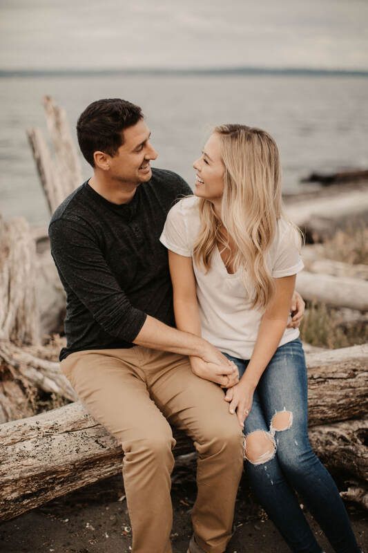 The couple walking barefoot as the surf rolls over their feet