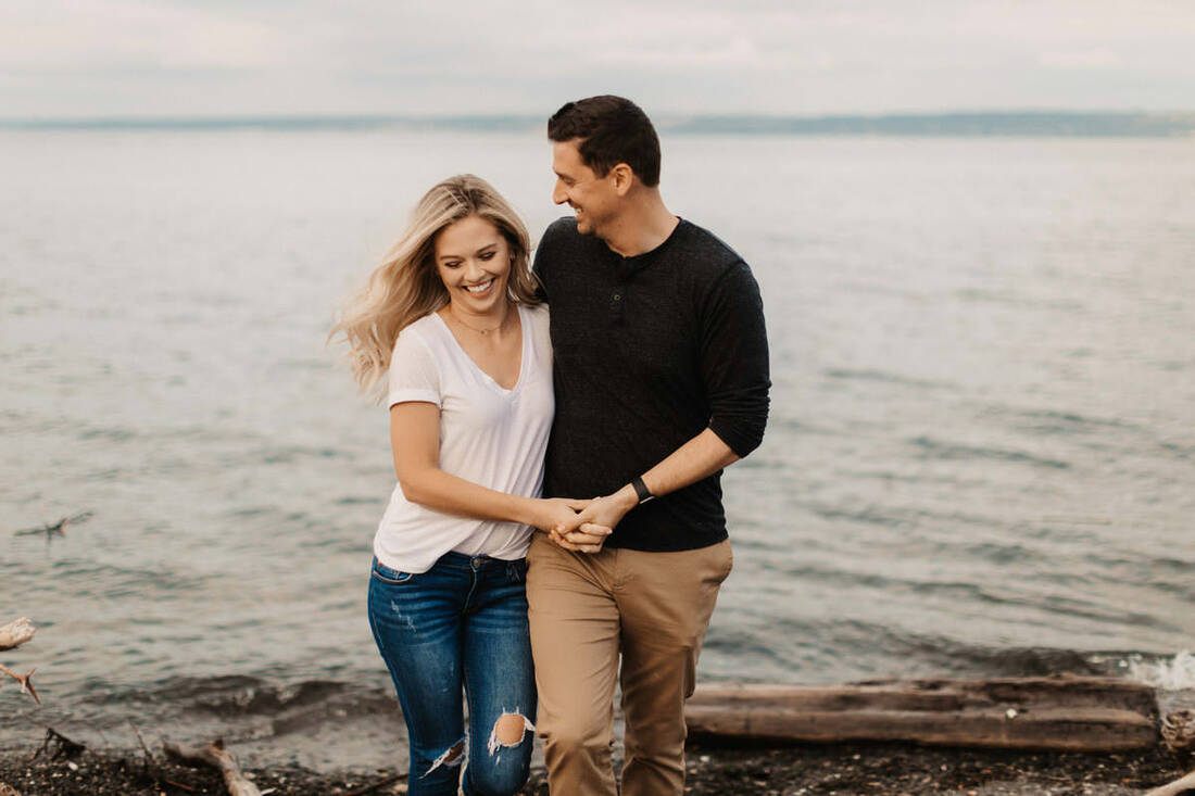 Candid portrait of the couple sharing a quiet moment by the water