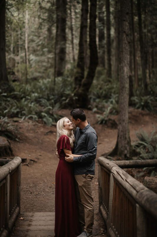 The couple surrounded by ferns and moss in the fading light