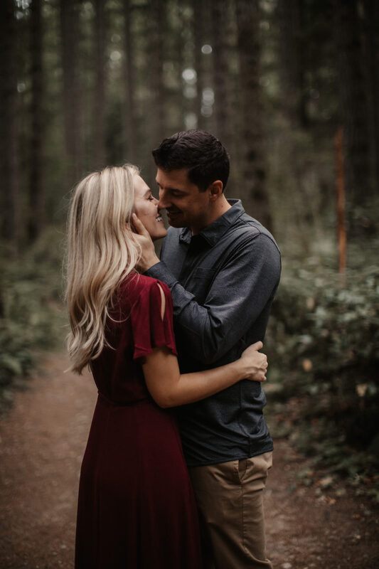 The couple embracing in the forest as evening light filtered through