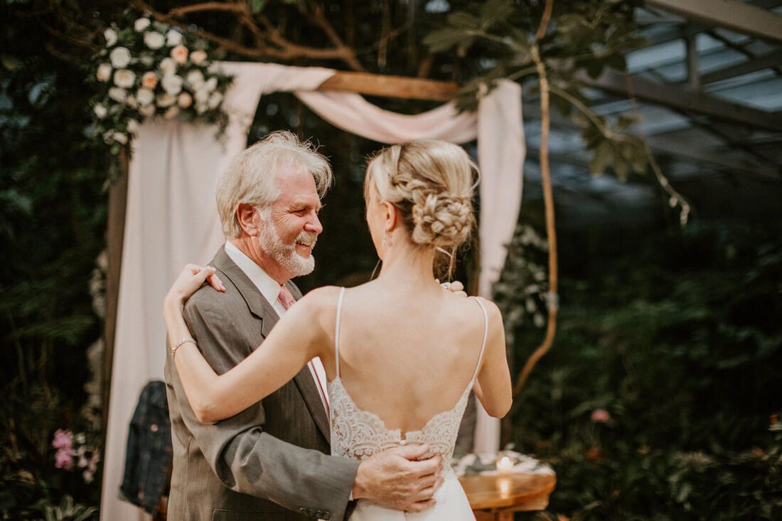 Close-up of Lindsey and John holding hands during their wedding vows