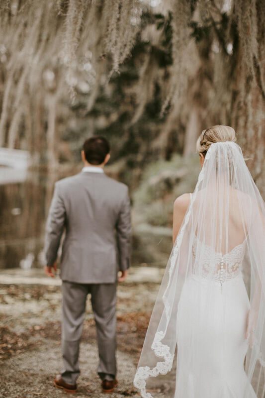 Lindsey and John walking hand in hand through the plantation gardens