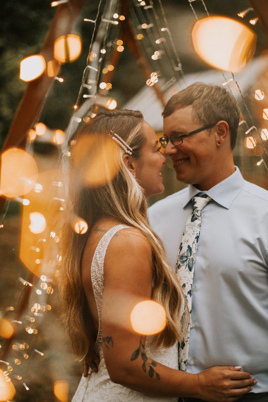 Close-up portrait of the couple at sunset by the river