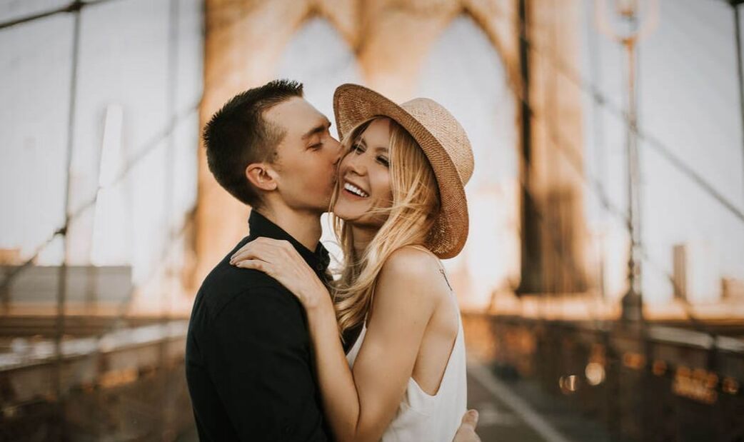 Engaged couple walking together through New York City