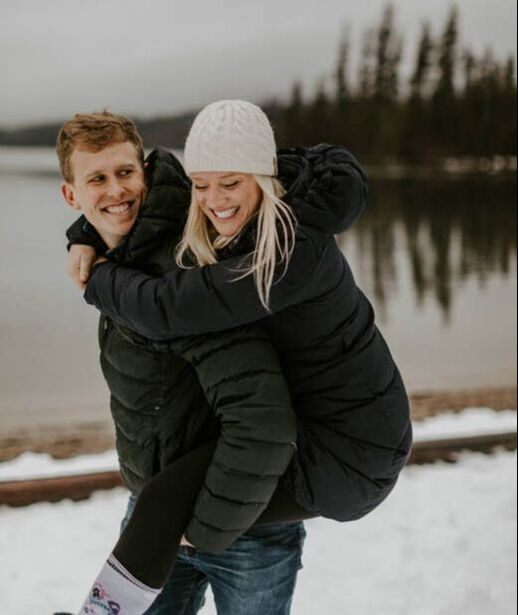 Couple embracing near their Washington cabin retreat