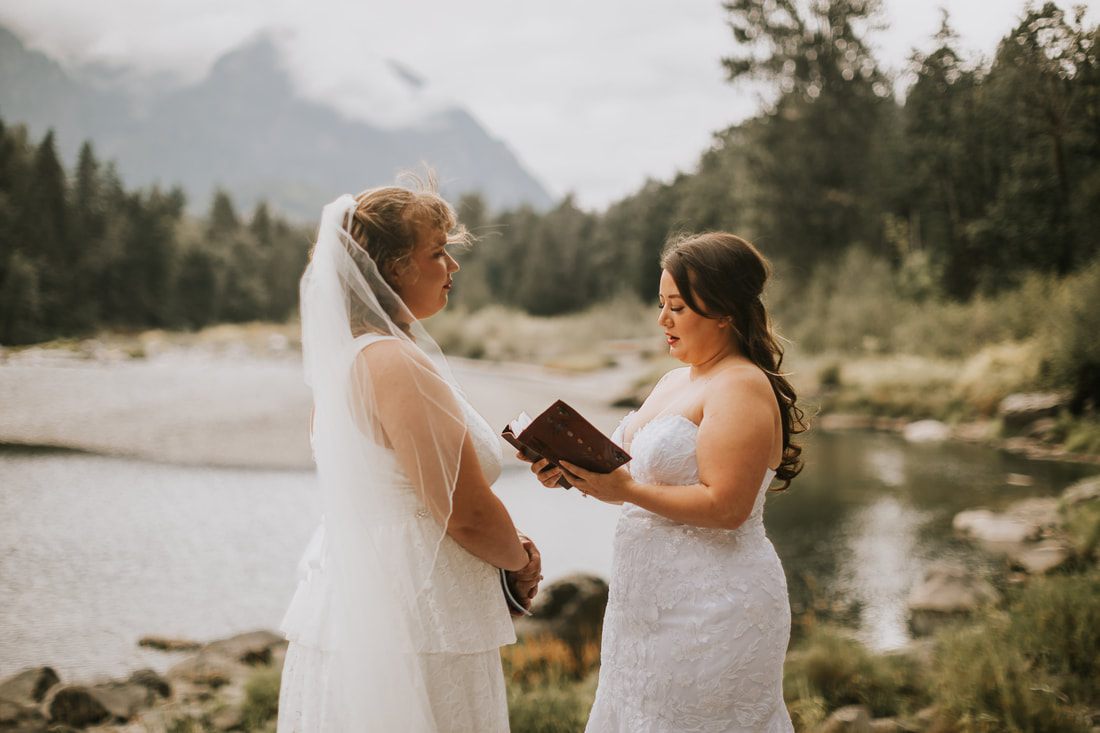 Two brides exchanging vows beneath the glass roof of the greenhouse ceremony, later in the celebration
