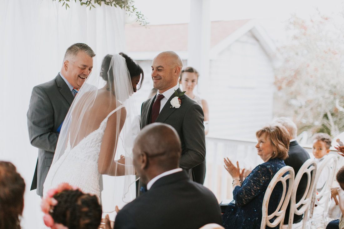 An emotional family reunion moment during the elopement weekend, back at the beach house