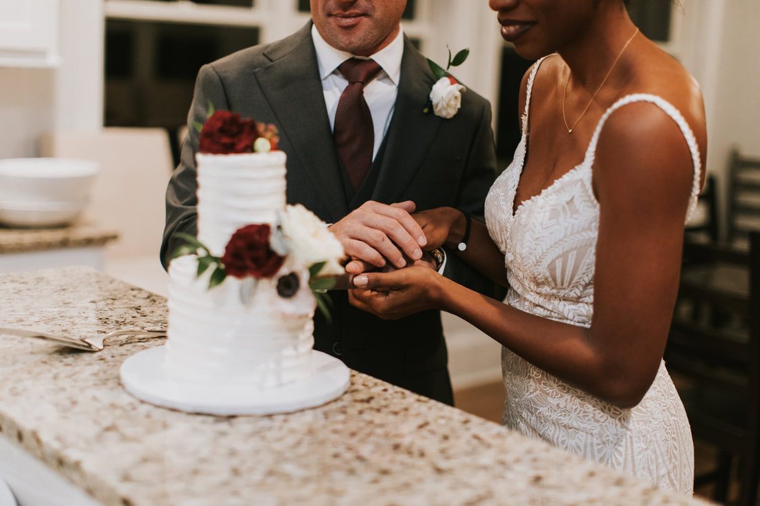 Close-up of the couple holding hands during their first look on the beach, one more frame from the day