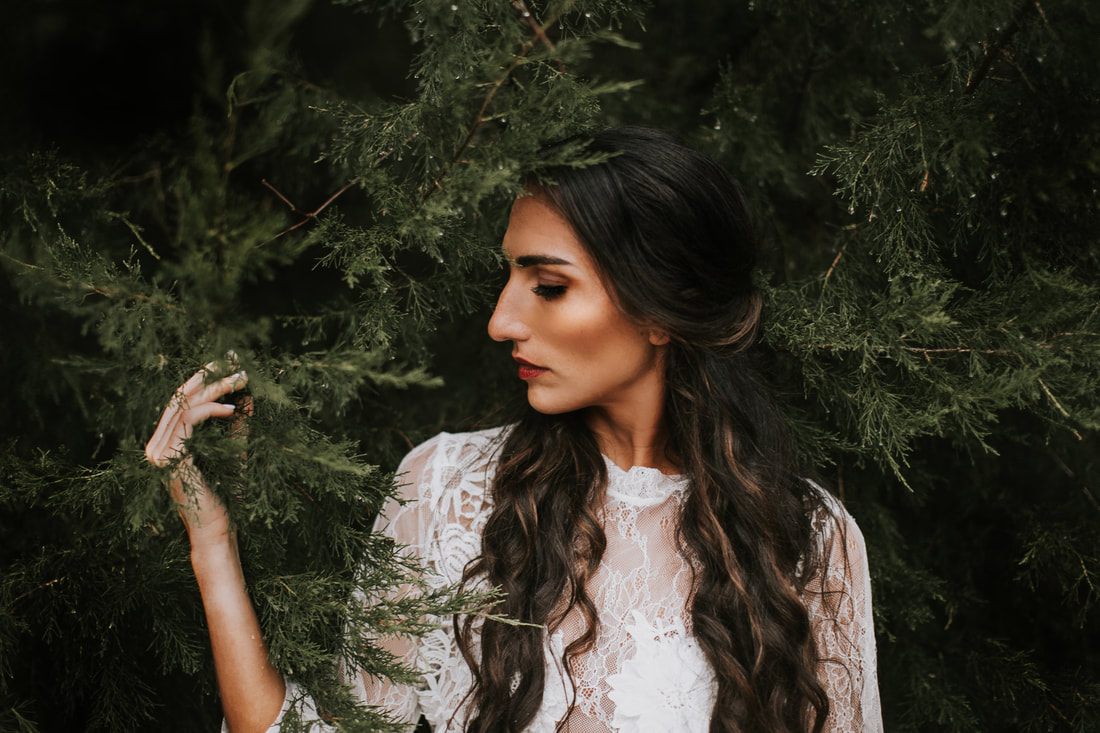 Full-length bridal portrait walking through a wooded Charleston forest