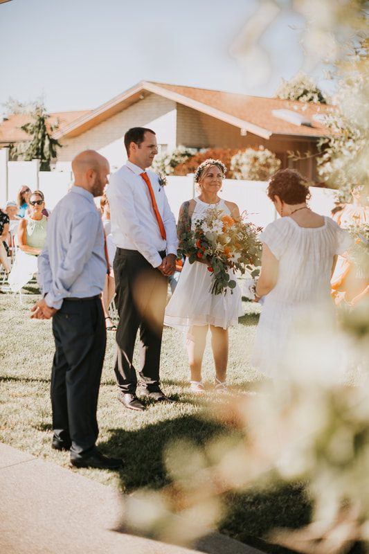 Close-up of the couple exchanging vows with Moses Lake in the background.