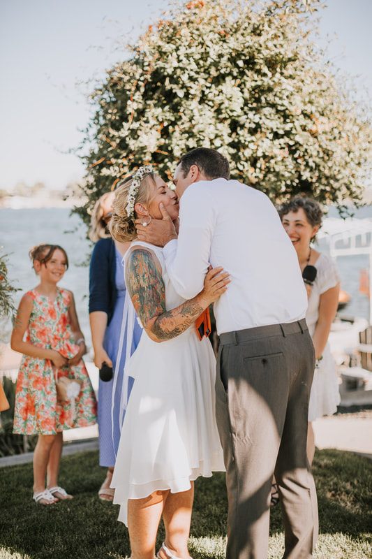Tomi and Daniel dancing together at their summer micro wedding celebration.