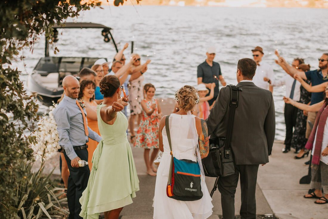 Guests laughing together during the intimate backyard reception at Moses Lake.