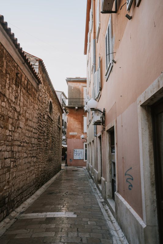 Photo of ancient ruins tucked into a modern streetscape in Croatia