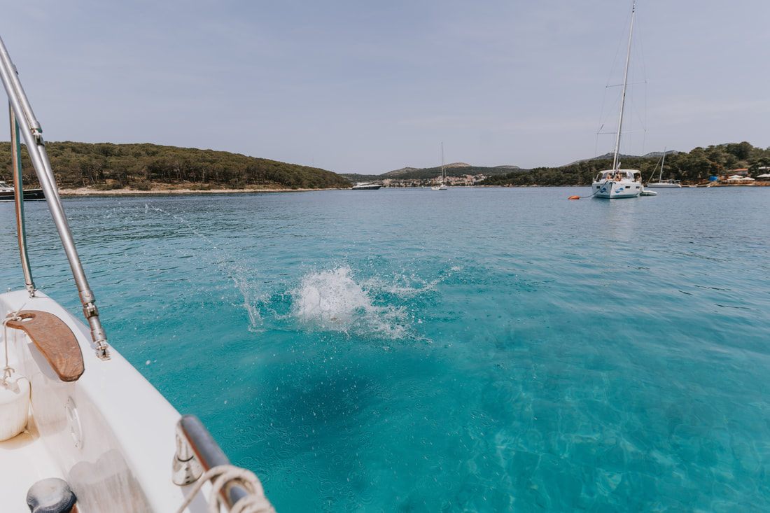 Photo of swimming in clear water off the rocky coast in Croatia