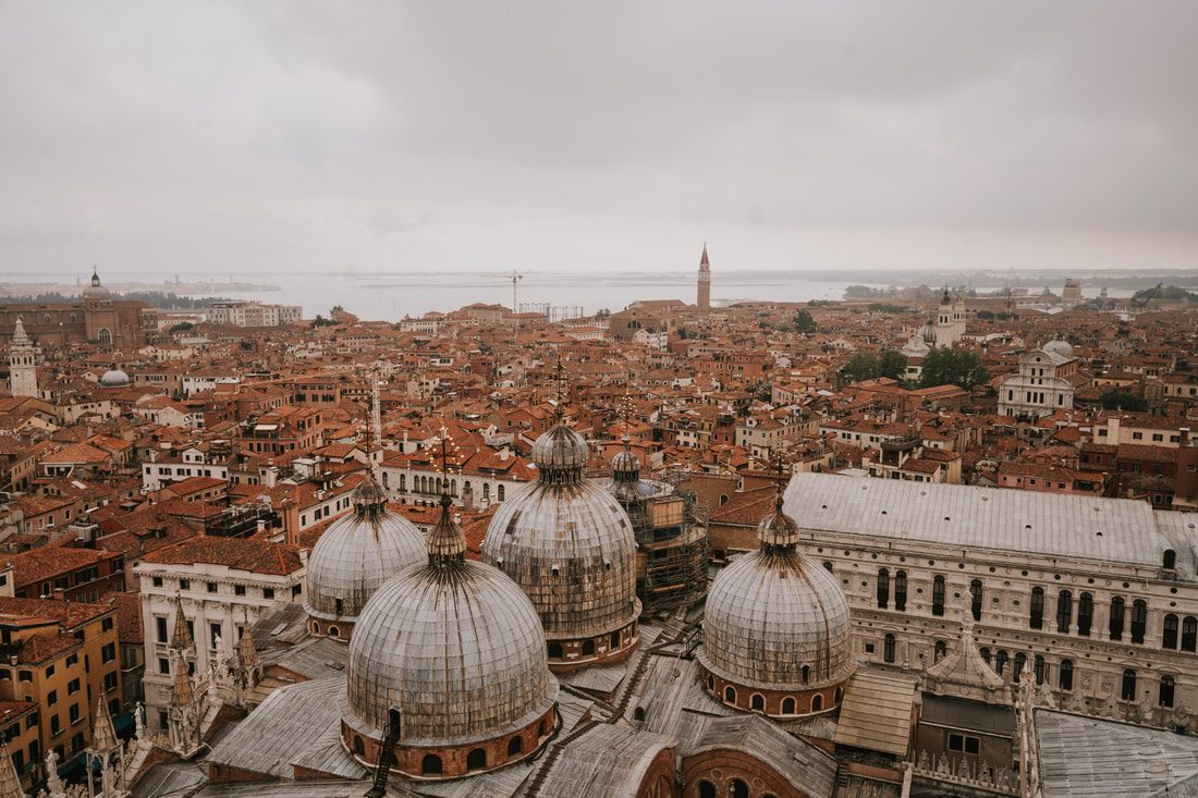 A narrow Venice alleyway winding toward the water