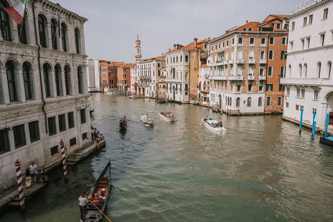 Venice canal lined with colorful buildings and boats
