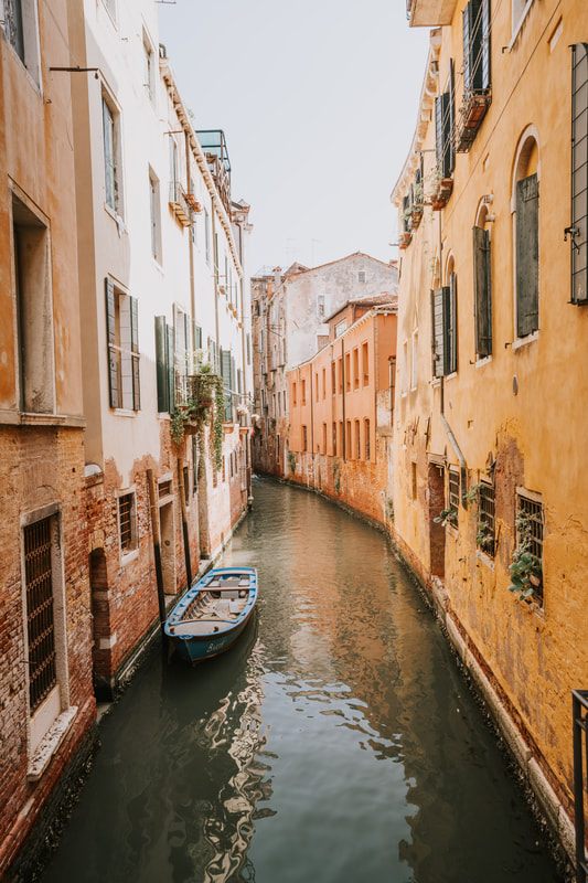 Sunlight on the water along a quiet Venice canal