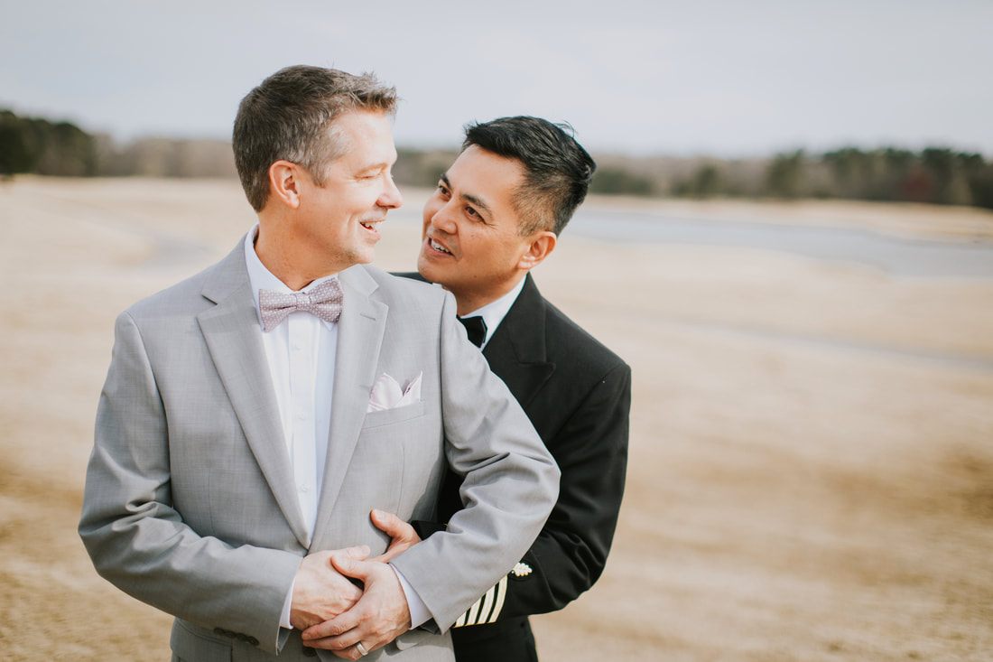 Fritz and Christopher embrace during their Virginia Beach wedding celebration.
