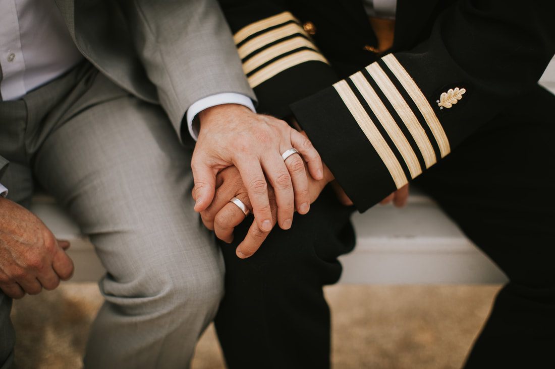 A candid portrait of Fritz and Christopher during their Virginia Beach wedding.