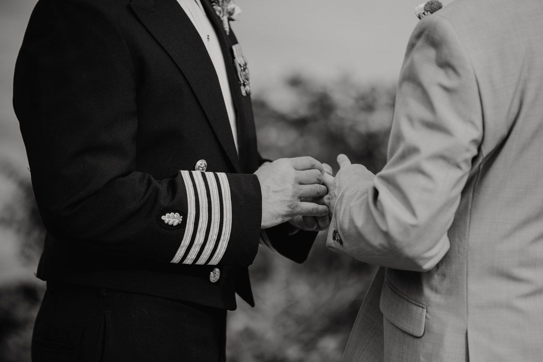 Fritz and Christopher laugh together during a candid wedding moment.