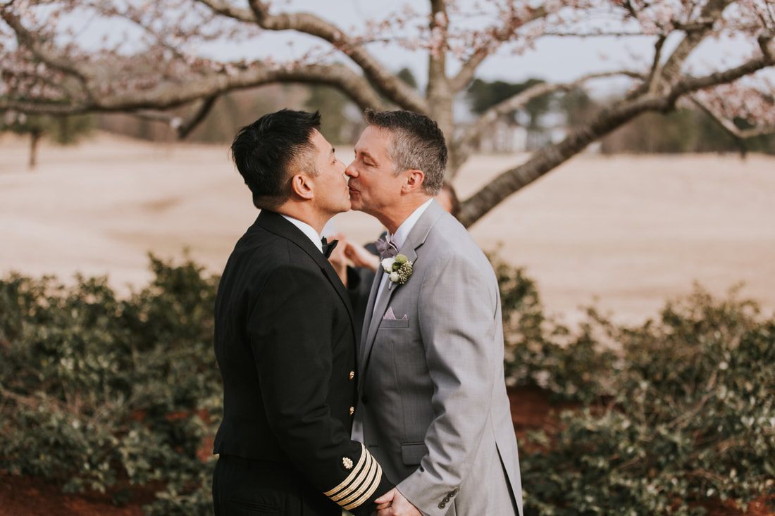 Fritz and Christopher embrace during their Virginia Beach wedding celebration.