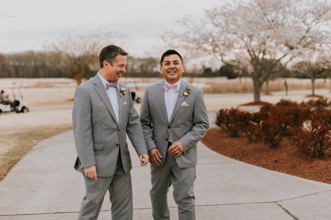 Fritz and Christopher pose together with the ocean behind them.