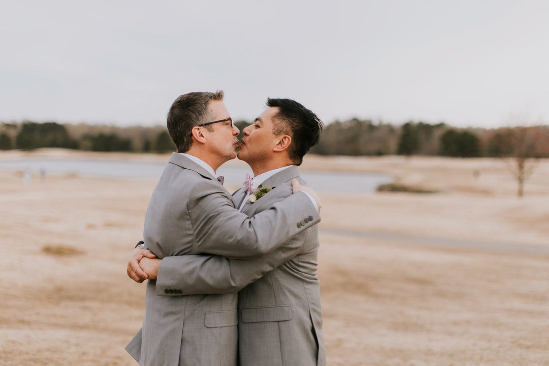 A candid portrait of Fritz and Christopher during their Virginia Beach wedding.